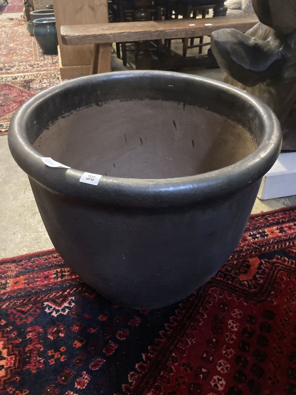 A large glazed gun metal garden planter, diameter 60cm